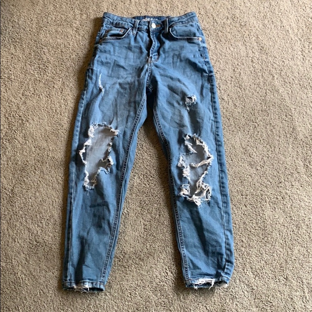 Women’s light blue ripped jeans.